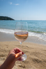 Cold rose wine from Provence served outdoor on white sandy beach Plage de Pampelonne near Saint-Tropez, France