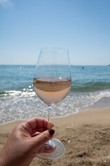 Cold rose wine from Provence served outdoor on white sandy beach Plage de Pampelonne near Saint-Tropez, France