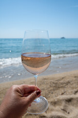 Cold rose wine from Provence served outdoor on white sandy beach Plage de Pampelonne near Saint-Tropez, France