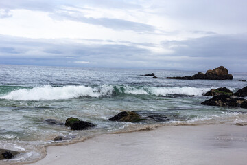 Fototapeta na wymiar A view on the ocean and rocks on a gloomy day