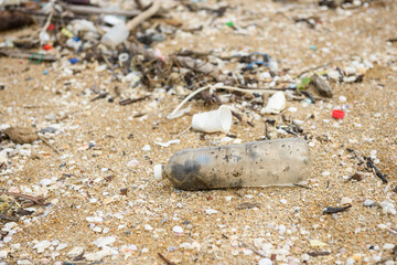 Plastic bottles and other trash on sea beach. Garbage on beach. Plastic at the ocean. Earth day globe Beach pollution Ecological concept.