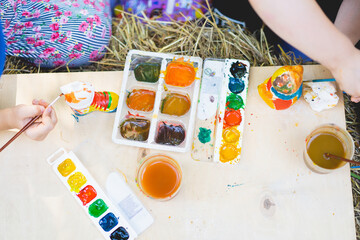 Children paint figurines with gypsum paints. Process of creation. Handmade concept