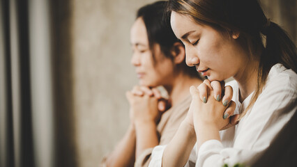  Two women praying worship believe