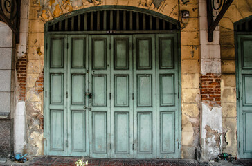 Wooden door in front of an old building in Bangkok, Thailand.