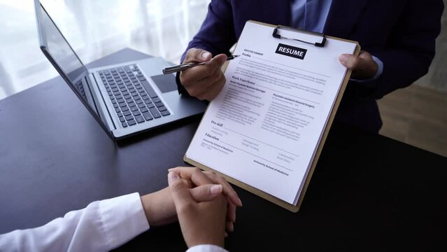 Young woman submit resume to employer to review job application. The concept presents the ability for the company to agree with the position of the job.