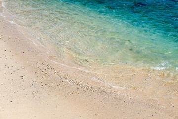 Fototapeta na wymiar Sand beach and turquoise seawater. Beautiful turquoise clear seawater at beach. Momong Beach, Lampuuk, Aceh.