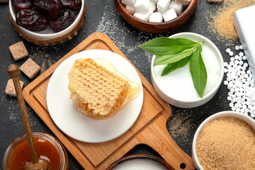 Various diet replacement for sugar on dark background.