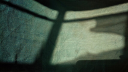 shadow of a Window on a piece of cloth in the morning. Light and shade concept.