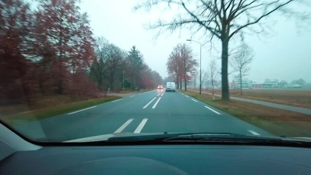 driving trough the dutch countryside in my car during autumn.