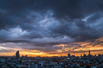 Fototapeta na wymiar Menacing storm above Bangkok city life in twilight time background