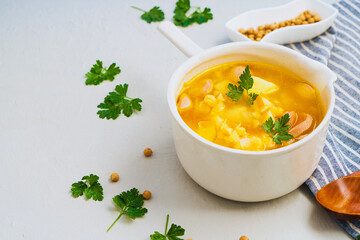Traditional tasty pea soup with smoked sausage served in white bowl