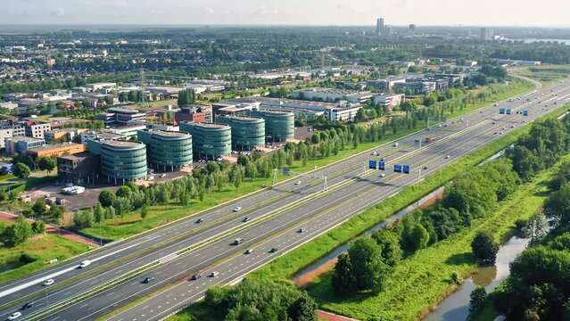 A6 Highway in Almere City, Flevoland, The Netherlands. Traffic between suburban city of Almere and Amsterdam. Aerial drone shot.