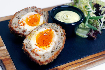 scotch eggs, deep fried boiled egg coated with mixture of pork mince with honey mustard and lettuce leaf