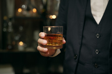 Businessmen in suits drinking whiskey
