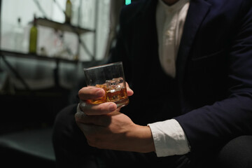Businessmen in suits drinking whiskey