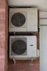 block of climatic equipment of the air conditioner hanging outside the building