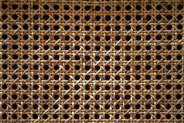 Woven bamboo strips close-up patterned bamboo rattan texture background.