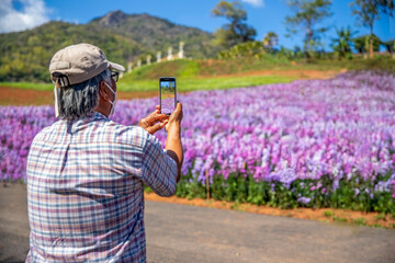 Selective focus of man's hands making photo on mobile phone camera is beautiful landscape