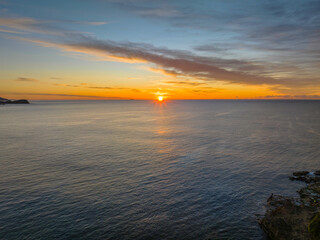 Sunrise over the sea with high cloud