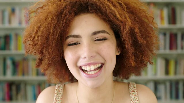 Closeup headshot and series collage of young, funky, cool woman laughing and smiling. Composite face portrait of afro woman showing variety of facial expressions in school library or community centre