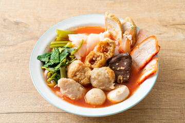 noodles with meatballs in pink soup