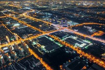 Aerial view of city skyline and road at night in Suzhou, China.