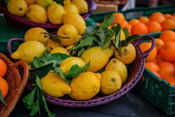 Ripe yellow lemons on a stand at a local outdoor farmers market Cours Saleya in the Old Town,...