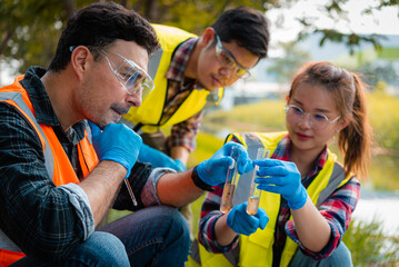 Scientists team collect water samples for analysis and research on water quality, environment with...