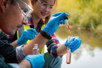 Scientists team collect water samples for analysis and research on water quality, environment with...