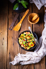 Pasta salad with green asparagus, olives and parma ham