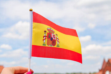 close up of National Spanish flag yellow and red colors,hand holding flag