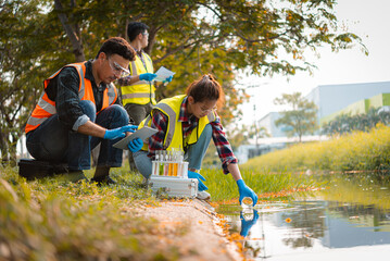Scientists team collect water samples for analysis and research on water quality, environment with...