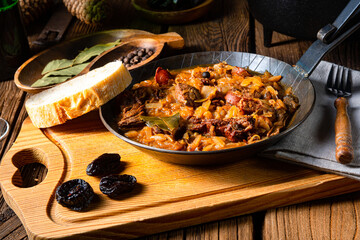 Polish bigos cooked according to an old recipe with wine and plum