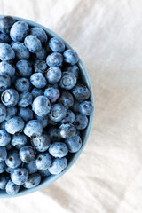 Raw Organic Blueberries in a Bowl, top view. Flat lay, overhead, from above. Copy space.