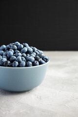 Raw Organic Blueberries in a Bowl, side view.