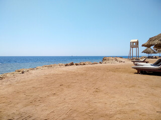 Fototapeta premium Beautiful view of the sea from a sandy beach with a rocky shore 