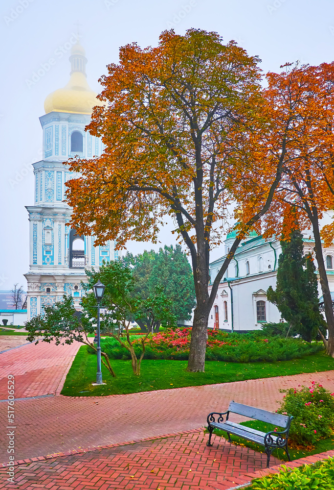 Wall mural The red horse-chestnut trees and foggy Bell Tower of St Sophia Cathedral, Kyiv, Ukraine