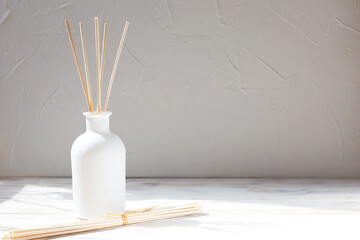 Aromatic reed diffuser with sticks on a white background