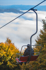 people on chairlift autumn season