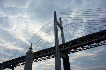 Fototapeta na wymiar View of bridge against cloudy sky. Impressive Yokohama bay bridge over Tokyo Bay
