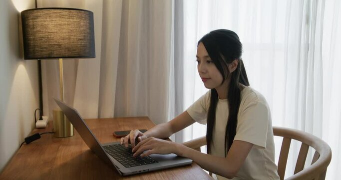 Woman type on laptop computer at room