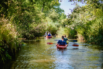 people on the river on a kayak - obrazy, fototapety, plakaty