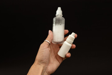 A girl is holding a vial of liquid in an urk - obrazy, fototapety, plakaty