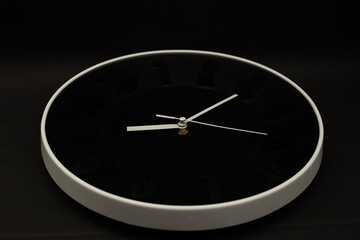 Wall clock on black background, subject photography