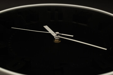 Wall clock on black background, subject photography