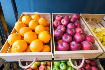 Healthy fruit and vegetables in grocery shop. Close up of baskets with apples and oranges in supermarket.