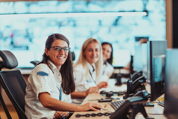 Group of female security operators working in a data system control room Technical Operators...