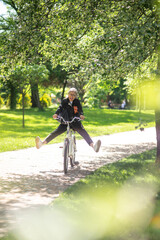 A woman enjoying a bike ride in the park