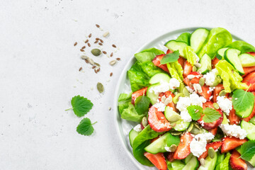Keto strawberry cucumber feta cheese salad. Top view, copy space, flat lay.