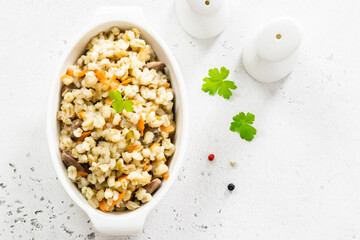Barley with vegetables and chicken. Top view, copy space, flat lay.